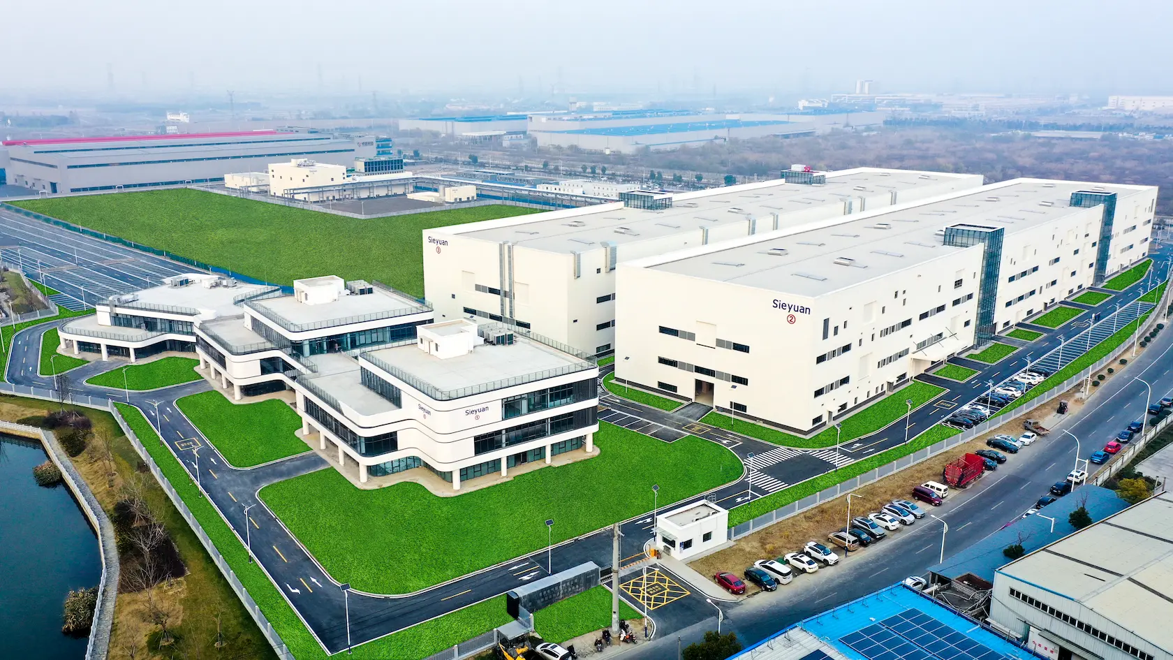 White office building compound with a large Sieyuan logo on the wall