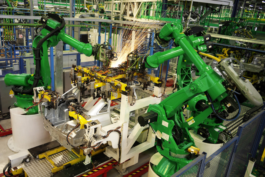 robot arms working in a car factory