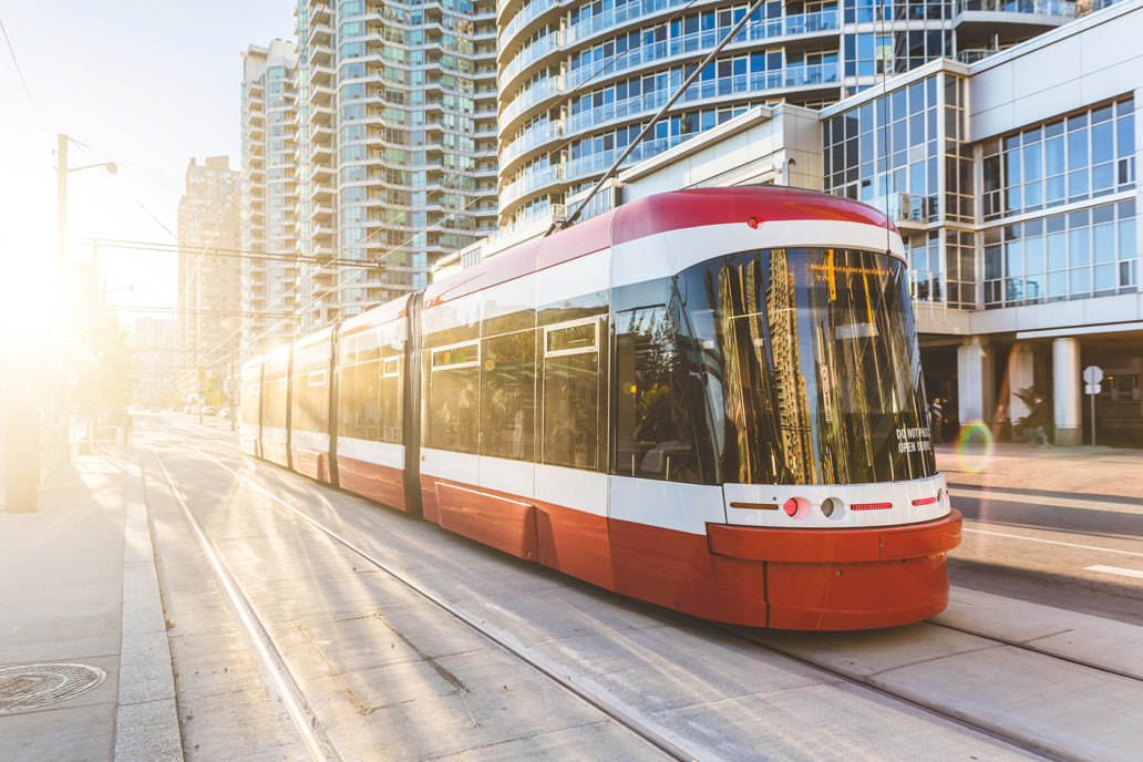 Modern tram in Toronto downtown at sunset.